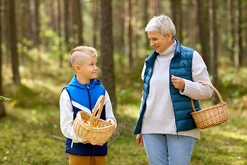 Image showing grandmother and grandson with mushrooms in forest