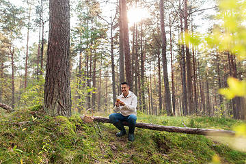 Image showing man with basket picking mushrooms in forest