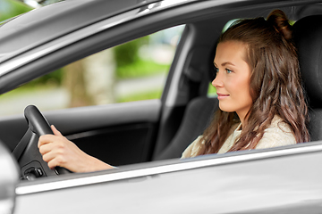 Image showing woman or female driver driving car in city