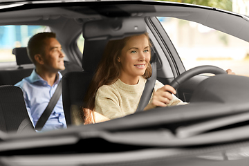 Image showing female driver driving car with male passenger