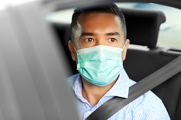 Image showing man or male passenger wearing mask in car