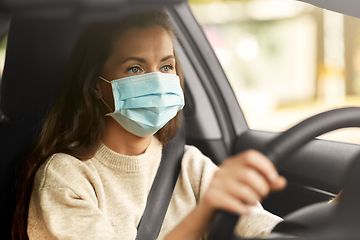 Image showing woman or female driver in mask driving car in city