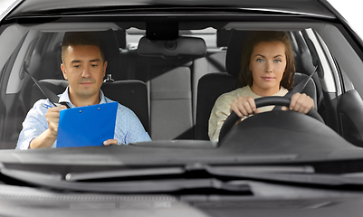 Image showing car driving school instructor and young driver