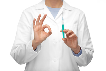 Image showing close up of doctor with syringe showing ok gesture