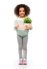 Image showing smiling girl holding flower and showing thumbs up