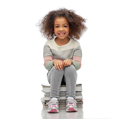 Image showing smiling girl with magazines sorting paper waste