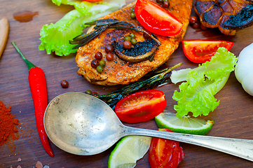 Image showing wood fired hoven cooked chicken breast on wood board