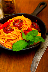 Image showing italian spaghetti pasta and tomato with mint leaves