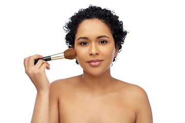 Image showing woman with make up brush applying blush to face