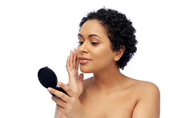 Image showing african american woman looking to mirror