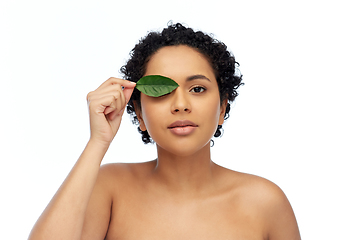 Image showing portrait of african american woman with green leaf