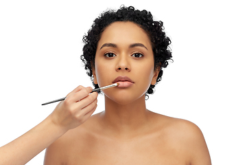 Image showing woman and hand of make up artist with brush