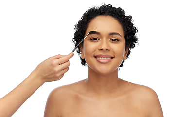 Image showing happy woman and hand of make up artist with brush