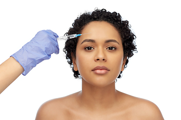 Image showing face of african woman and hand with syringe