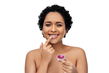 Image showing african american woman applying lip gloss