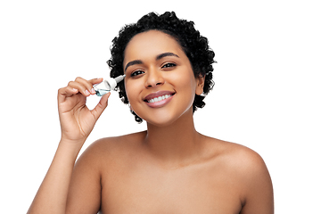 Image showing happy young african american woman with eye drops