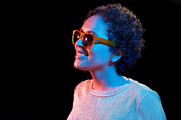 Image showing african woman in sunglasses over neon lights