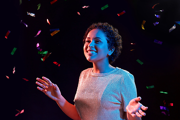 Image showing african woman under confetti at nightclub party