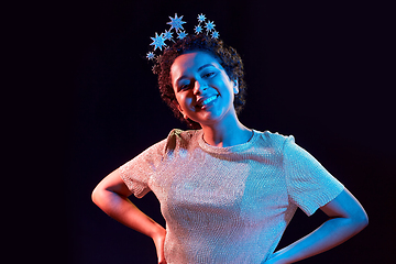 Image showing african woman in party crown over black background