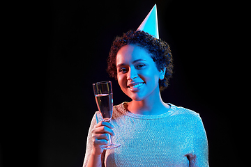 Image showing african woman in party cap with glass of champagne