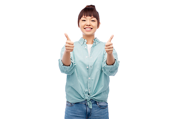 Image showing happy asian woman showing thumbs up over white