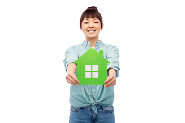 Image showing smiling asian woman holding green house