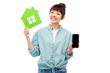 Image showing smiling asian woman holding green house