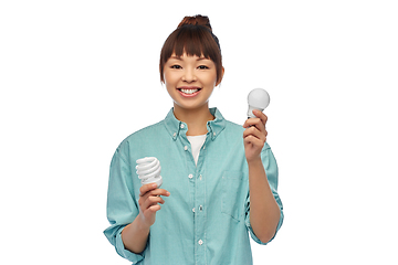 Image showing asian woman holding energy saving lighting bulb