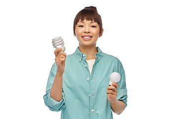 Image showing asian woman holding energy saving lighting bulb