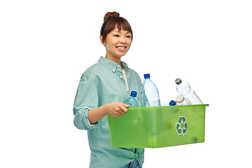 Image showing smiling young asian woman sorting plastic waste