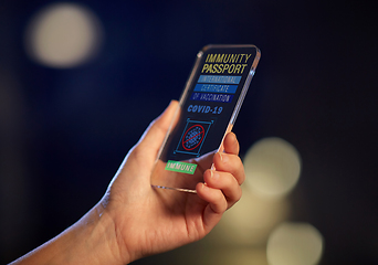 Image showing hand holding phone with certificate of vaccination