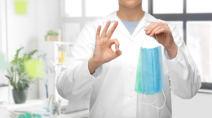 Image showing female doctor with medical mask showing ok gesture