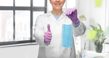 Image showing female doctor with medical mask showing thumbs up