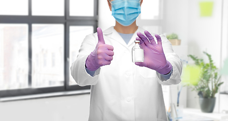 Image showing close up of doctor with medicine showing thumbs up