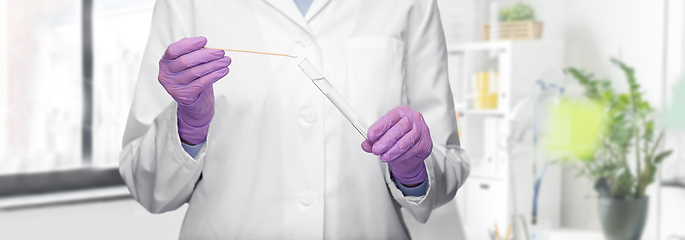 Image showing female doctor with test tube and cotton swab