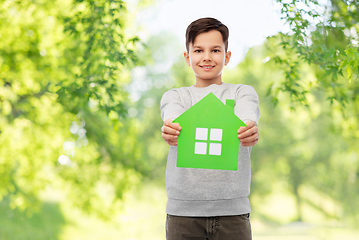 Image showing smiling boy holding green house icon