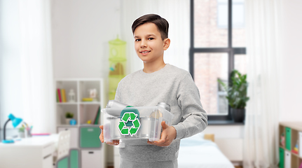 Image showing smiling boy sorting metallic waste at home