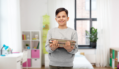 Image showing smiling boy with magazines sorting paper waste