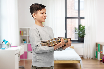 Image showing smiling boy with magazines sorting paper waste