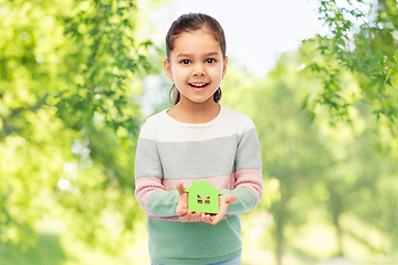 Image showing smiling little girl holding green house icon