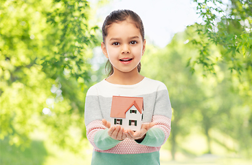 Image showing smiling girl holding house model