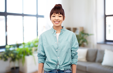 Image showing happy asian woman over home background