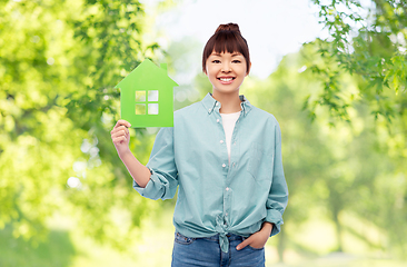 Image showing smiling asian woman holding green house