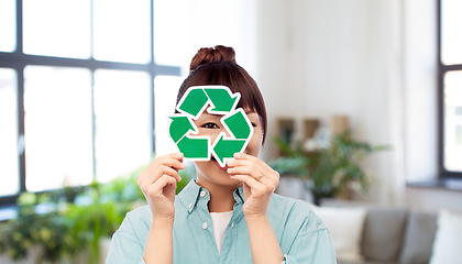 Image showing smiling asian woman holding green recycling sign