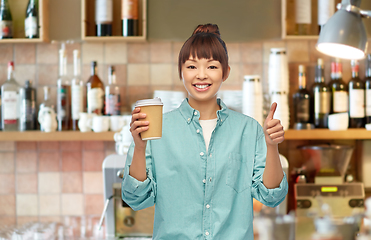 Image showing asian woman with coffee showing thumbs up at bar