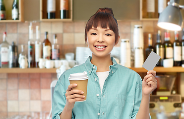 Image showing asian woman with coffee and credit card at bar