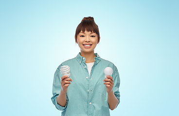 Image showing asian woman holding energy saving lighting bulb