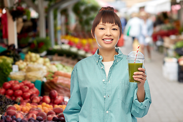 Image showing happy asian woman with drink at street market