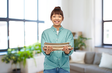 Image showing smiling young asian woman sorting paper waste