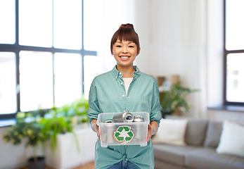 Image showing smiling young asian woman sorting metallic waste